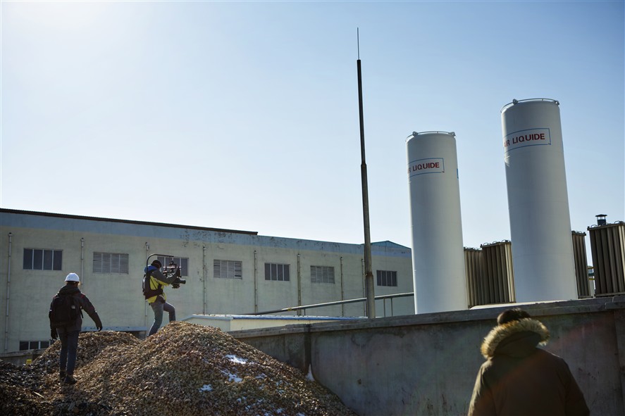 Dongguan production team discussing a brief near a location setup